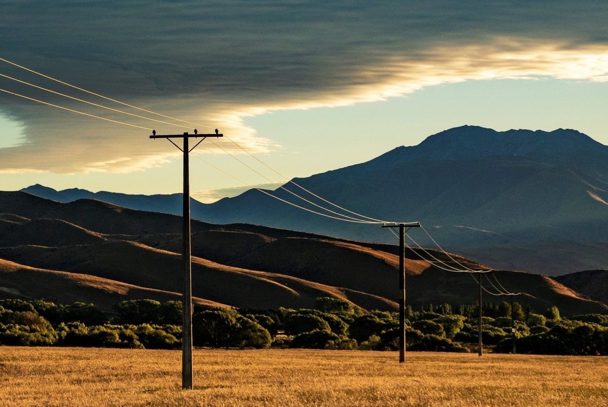 A field with power lines and mountains in the background, showcasing FME Utilities.